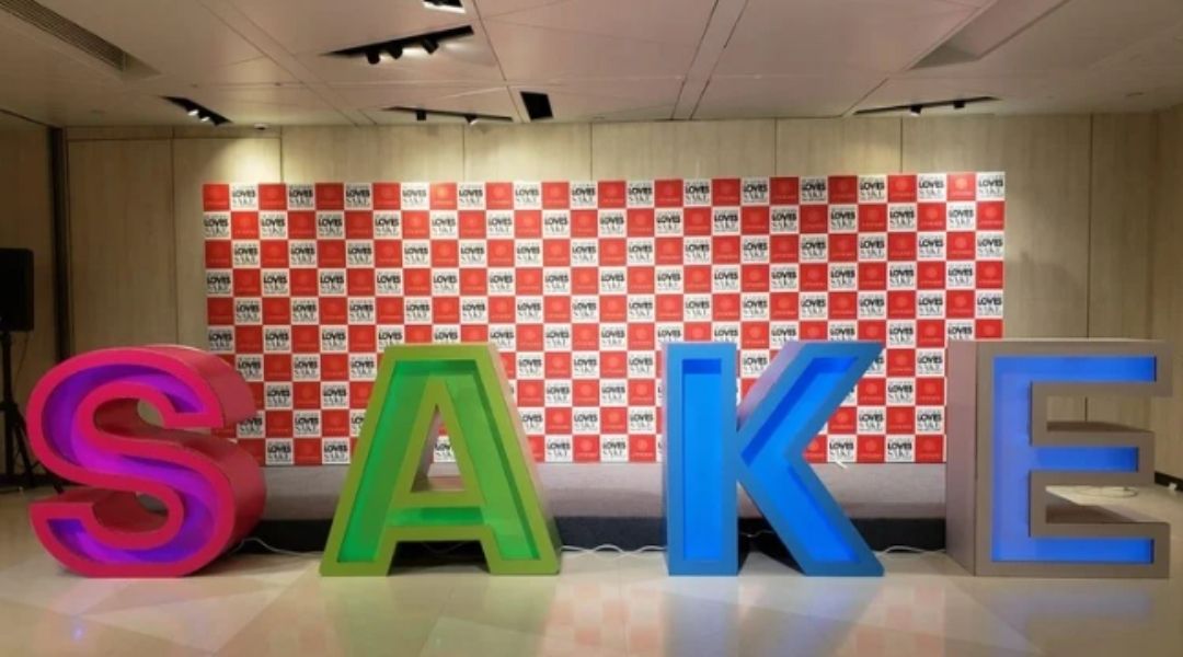 Seafood Loves Sake — SAKE letter installation with branded backdrop
